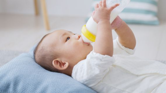baby drinking from bottle formula